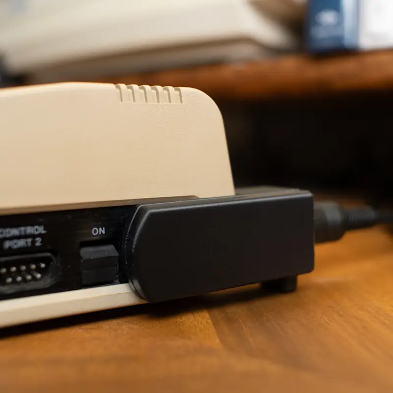 A side view of a C64 case using a right-angle power adapter.
